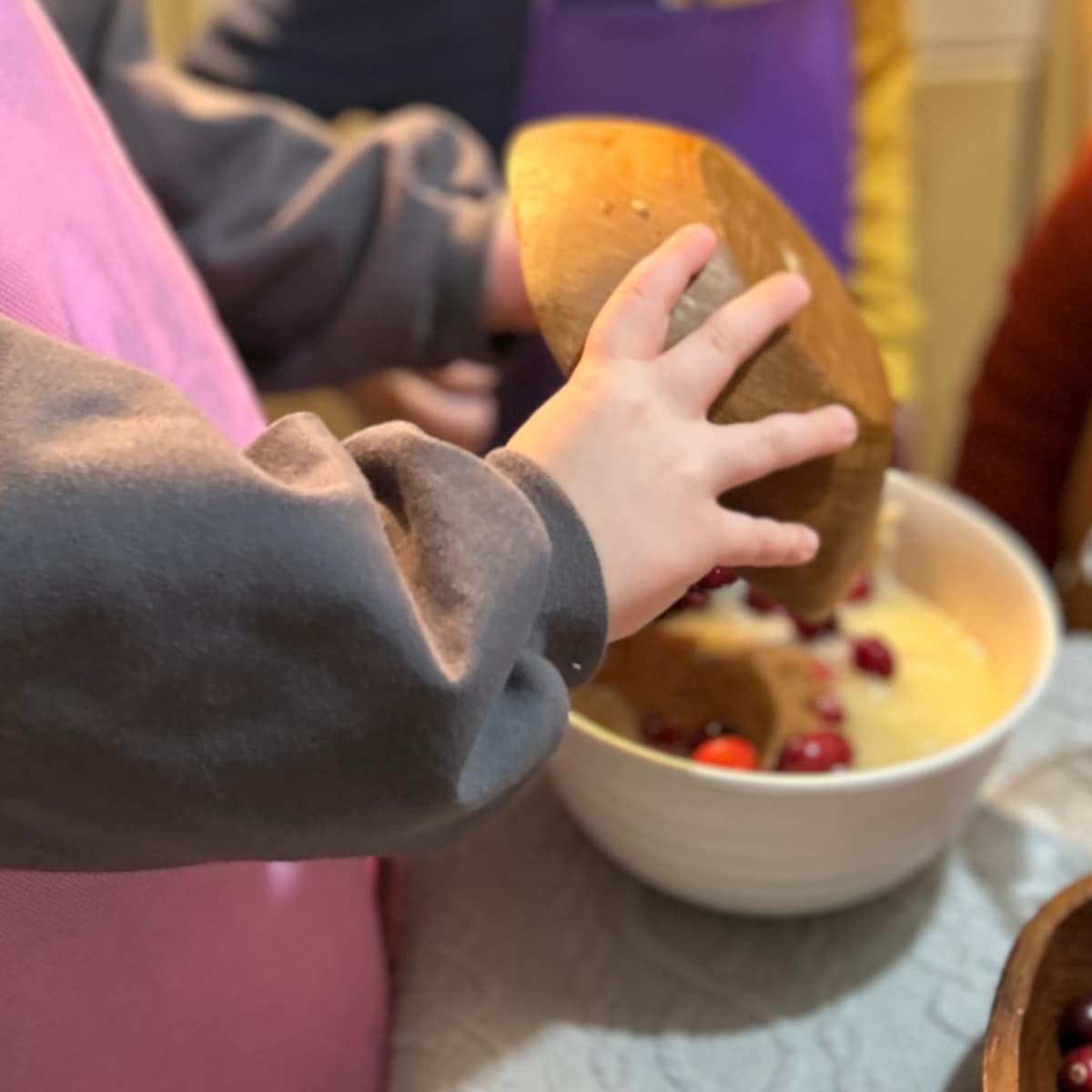 Child pouring in cranberries.jpg